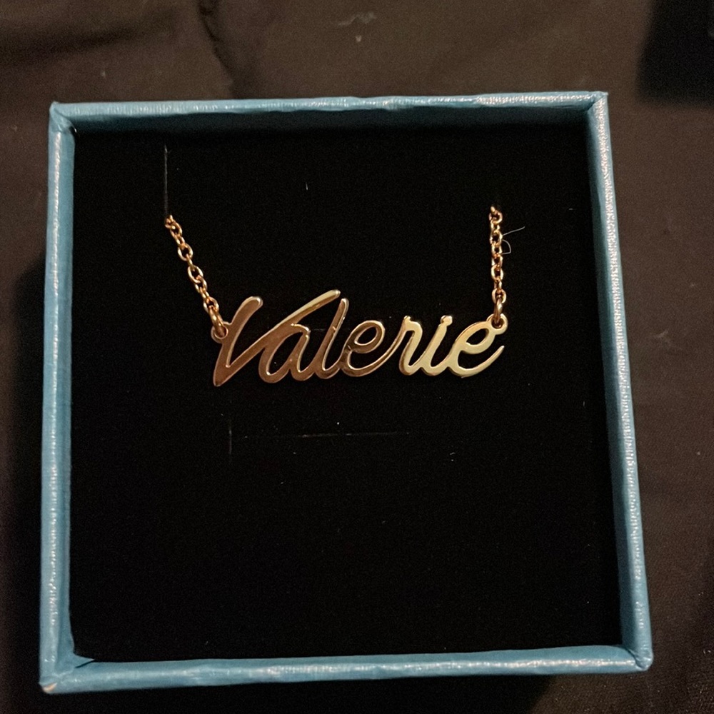 Gold colored name plate necklace. (Valerie)